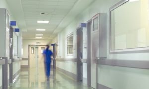 nurse walking down hallway of hospital